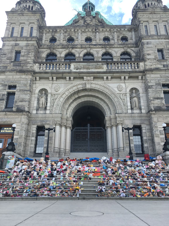 legislative steps of Victoria BC parliament buildings covered in toys and shoes for the first nations children on truth and reconcillation day