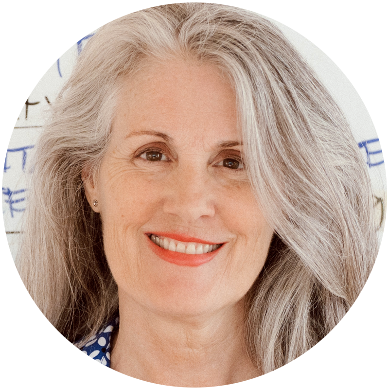 Christina Merkley long hair down smiling at the cameral with a visual map in the background.